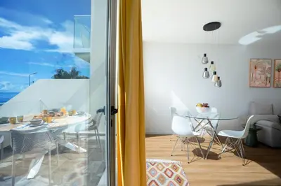 a dining room with a table and a glass door at CasaNova by LovelyStay in Santa Cruz