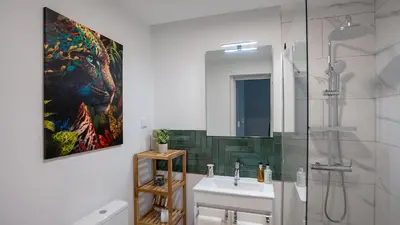 a bathroom with a sink and a painting on the wall at CasaNova by LovelyStay in Santa Cruz