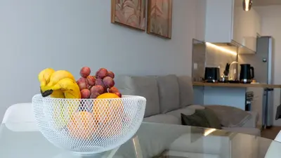 a bowl of fruit sitting on a glass table at CasaNova by LovelyStay in Santa Cruz