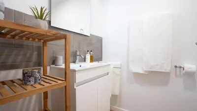 a bathroom with a white sink and a white counter at CasaNova by LovelyStay in Santa Cruz
