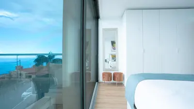 a bedroom with a bed and a view of the ocean at CasaNova by LovelyStay in Santa Cruz