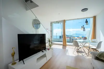 a living room with a large flat screen tv at CasaNova by LovelyStay in Santa Cruz
