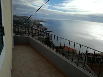a balcony with a view of the ocean at Casa do Pico in Câmara de Lobos