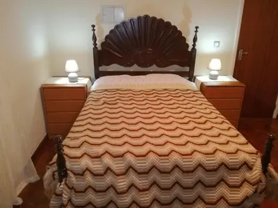 a bedroom with a large bed with two night stands at Casa do Pico in Câmara de Lobos