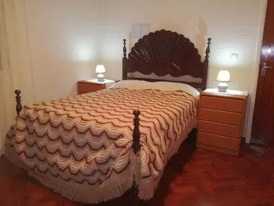 a bedroom with a large bed with two night stands at Casa do Pico in Câmara de Lobos
