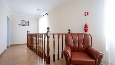 a brown leather chair sitting on a staircase at Marroas Cottage in Ponta do Sol
