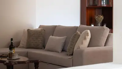 a couch with pillows on it in a living room at Marroas Cottage in Ponta do Sol