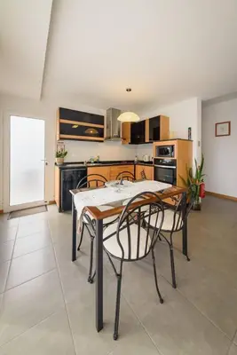 a kitchen with a table and chairs in a room at Vivenda Carlota Sea View by Mth in Ribeira Brava