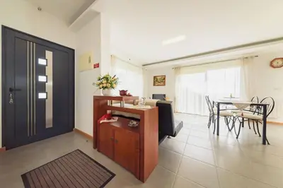 a living room with a door and a table with chairs at Vivenda Carlota Sea View by Mth in Ribeira Brava