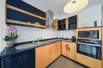 a kitchen with wooden cabinets and a sink at Vivenda Carlota Sea View by Mth in Ribeira Brava