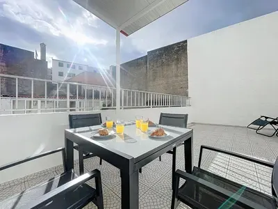 a table with food and drinks on a balcony at CityZen Funchal by Atlantic Holiday in Funchal