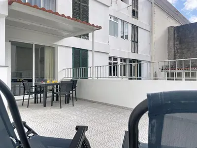 a balcony with a table and chairs on a building at CityZen Funchal by Atlantic Holiday in Funchal