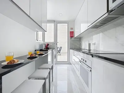a kitchen with white counters and white appliances at CityZen Funchal by Atlantic Holiday in Funchal