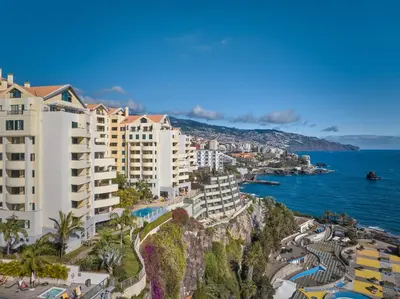 a view of a city and the ocean with buildings at Urso Tigre Apartment by Holiday Rental Madeira in Funchal