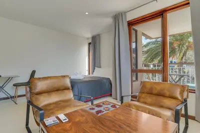a room with a bed and a table and chairs at Urso Tigre Apartment by Holiday Rental Madeira in Funchal