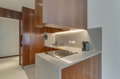 a kitchen with a sink and wooden cabinets at Urso Tigre Apartment by Holiday Rental Madeira in Funchal
