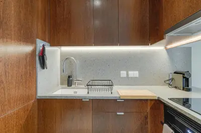 a kitchen with a sink and wooden cabinets at Urso Tigre Apartment by Holiday Rental Madeira in Funchal