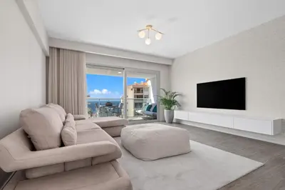 a living room with a couch and a flat screen tv at Atlantic View by An Island Apart in Funchal