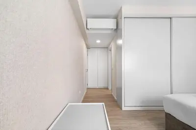 a room with a white table and a white wall at Atlantic View by An Island Apart in Funchal