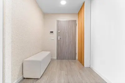 a hallway with a door and a white stool at Atlantic View by An Island Apart in Funchal