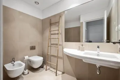 a bathroom with a sink and a toilet and a mirror at SeaSide Serenity in Funchal