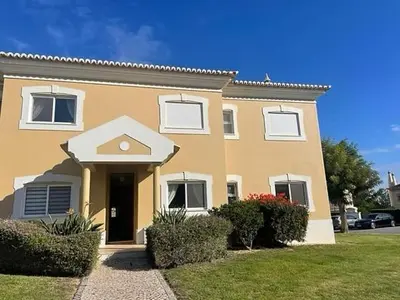 a large yellow house with bushes in front of it at Fairviews Boavista , Boavista golf and spa resort Lagos in Lagos