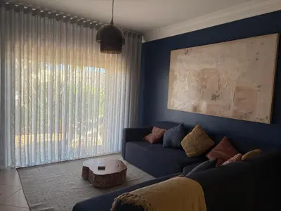 a living room with a blue couch and a table at Fairviews Boavista , Boavista golf and spa resort Lagos in Lagos