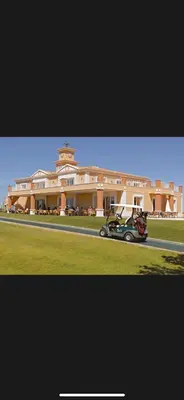 a car parked in front of a large building at Fairviews Boavista , Boavista golf and spa resort Lagos in Lagos