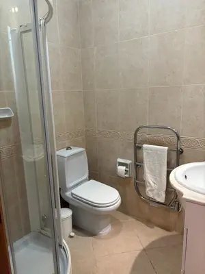 a bathroom with a toilet and a sink and a shower at Fairviews Boavista , Boavista golf and spa resort Lagos in Lagos