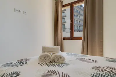 a bed with two towels sitting on top of it at Carlos Apartment by Holiday Rental Madeira in Funchal