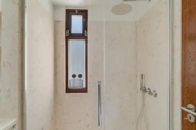 a shower with a glass door and a window at Carlos Apartment by Holiday Rental Madeira in Funchal