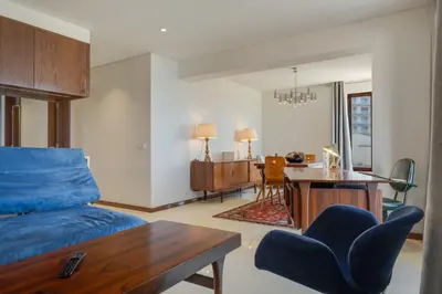 a living room with a blue couch and a table at Carlos Apartment by Holiday Rental Madeira in Funchal