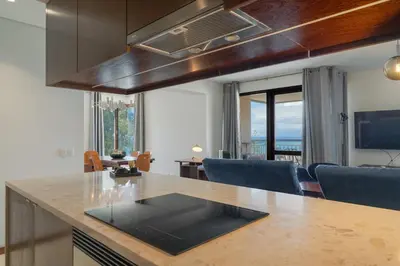 a kitchen with a counter with a view of a living room at Carlos Apartment by Holiday Rental Madeira in Funchal