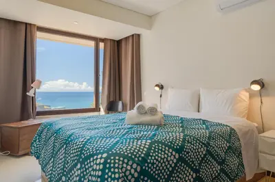 a bedroom with a bed and a large window at Carlos Apartment by Holiday Rental Madeira in Funchal