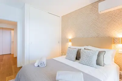 a bedroom with a large bed with a clock on it at Satoshi Ocean View in Funchal