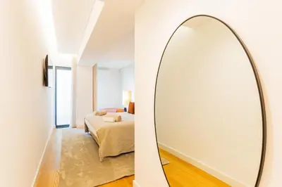 a mirror in a bedroom with a bed at Satoshi Ocean View in Funchal