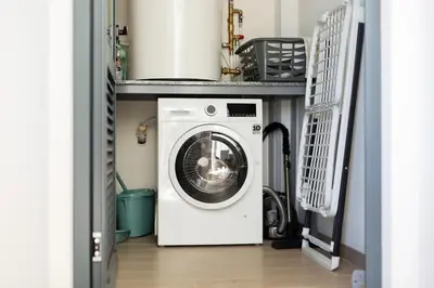 a washer and dryer in a laundry room at Satoshi Ocean View in Funchal