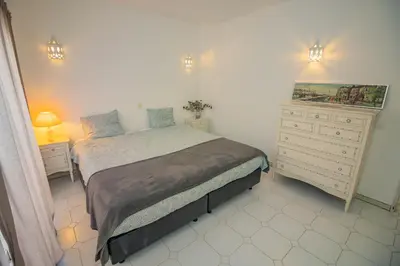 a small bedroom with a bed and a dresser at Apartamento Casa do Mar Praia da Luz in Luz