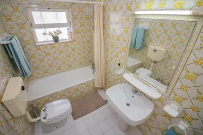 a bathroom with a sink and a toilet and a mirror at Apartamento Casa do Mar Praia da Luz in Luz