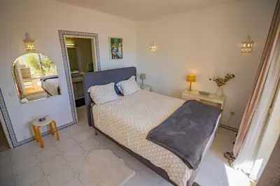 a bedroom with a bed and a large mirror at Apartamento Casa do Mar Praia da Luz in Luz