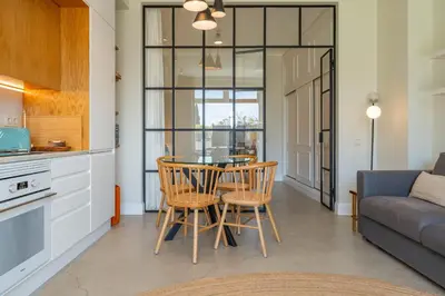 a kitchen and dining room with a table and chairs at FLH Funchal Terrace Studio in Funchal
