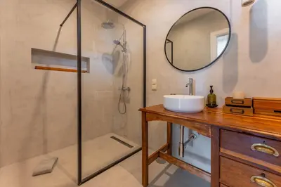 a bathroom with a shower and a sink and a mirror at FLH Funchal Terrace Studio in Funchal