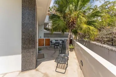 an outdoor patio with benches and a palm tree at FLH Funchal Terrace Studio in Funchal