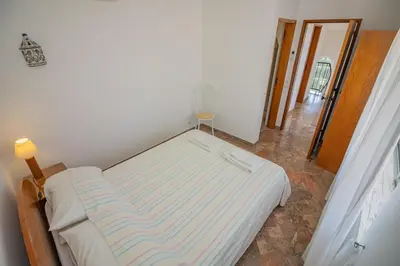 a small bedroom with a bed in a room at Casa dos Sonhos Praia da Luz in Luz
