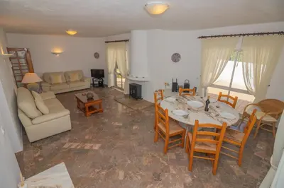 a living room with a table and chairs and a couch at Casa dos Sonhos Praia da Luz in Luz