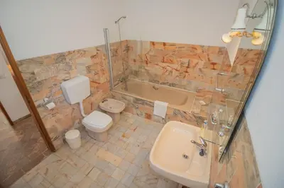 a bathroom with a tub and a toilet and a sink at Casa dos Sonhos Praia da Luz in Luz