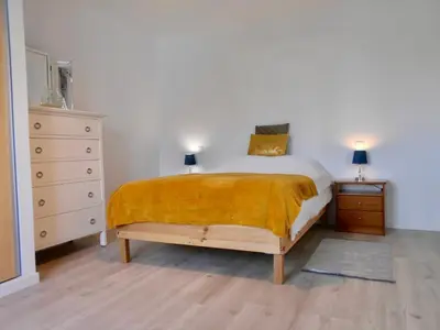 a bedroom with a bed and a dresser and two lamps at Casa Bamboo central Funchal Villa in Funchal