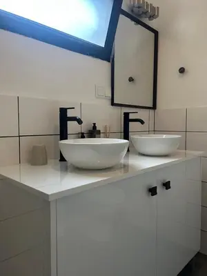 a bathroom with two sinks on a counter at Casa Bamboo central Funchal Villa in Funchal