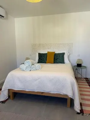 a bedroom with a bed with towels on it at Casa Bamboo central Funchal Villa in Funchal