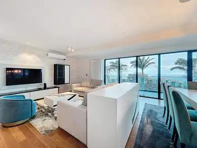 a living room with a couch and a television at Varinos Seaview Apartment in Funchal